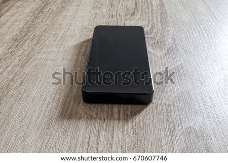 power bank phone charger isolated on wooden background