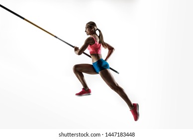 Power And Beauty And Purity. Professional Female Pole Vaulter Training On White Studio Background. Fit And Slim Female Model Practicing. Concept Of Sport, Healthy Lifestyle, Action, Movement, Motion.