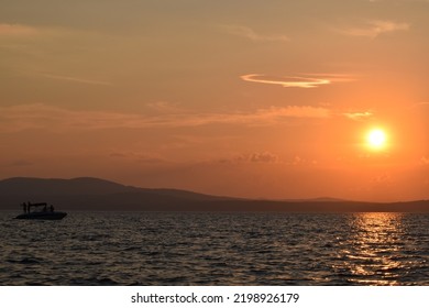 Power Boat On Sebago Lake In Maine At Sunset.