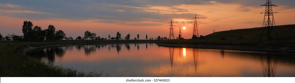 power cable line. sunset on the river - Powered by Shutterstock