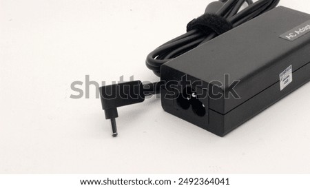 Power cable and notebook adapter, on a white background.
