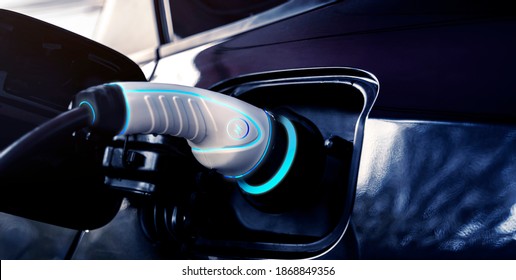 Power cable pump plug in charging power to electric vehicle EV car with modern technology UI control information display, car fueling station connected power cable alternative sustainable eco energy - Shutterstock ID 1868849356