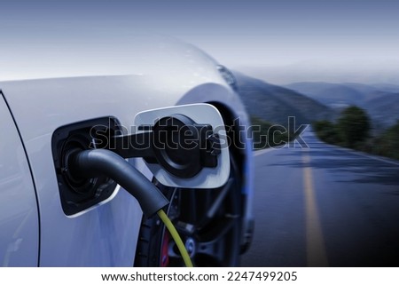 Power cable pump plug in charging power to electric vehicle EV car.