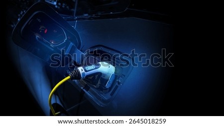Power cable pump plug in charging power to electric vehicle EV car.