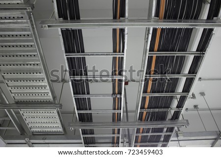 Power cables, Control cables and Instrument cables install on cable ladder and cable tray which fix support with concrete ceiling in electrical room