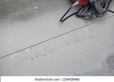 Power Circular Saw Blade Cutting Fresh Concrete