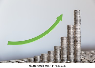 The power of compounding interest pictured with stack of coins.