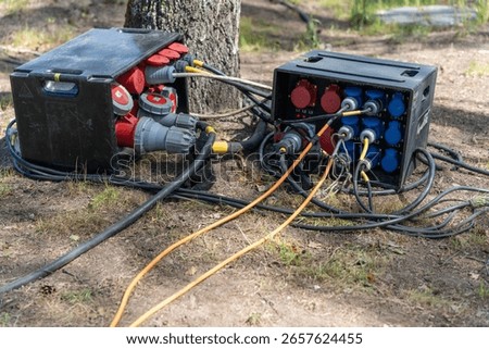 Power distribution boxes and cables supplying electricity for outdoor event