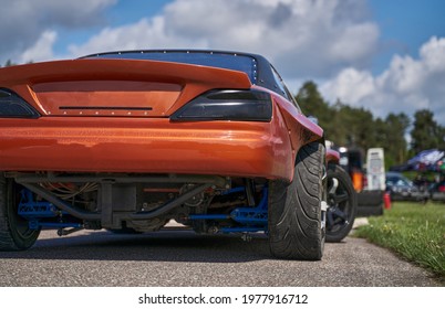 Power drifting car from side. back view