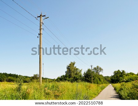 Power electric pole with line wire on colored background close up. Photography consisting of power electric pole with line wire under sky. Line wire in power electric pole for residential buildings.