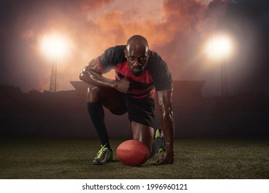 Power, energy. Professional male rugby player posing isolated on stadium background. African fit athlete preparing for match. Concept of health, sport, action, motion, competition. - Powered by Shutterstock