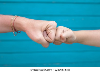 Power Five, Fist Bump Or Brofist. Close-up Of Child And Mother Fists Touching Each Other