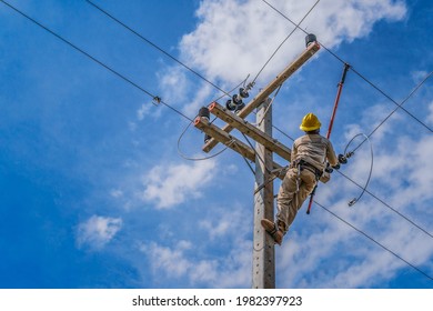 The power lineman use clamp stick (insulated tool) to closing a transformer on energized high-voltage electric power lines. The power lineman must be trained because it is a risky job