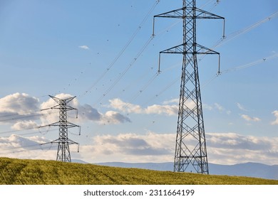 Power lines. Energy industry. Industrial electricity trasmission. Renewable production - Shutterstock ID 2311664199