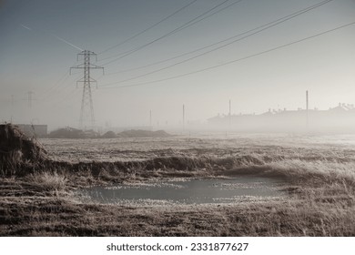 Power lines in winter in a frozen landscape