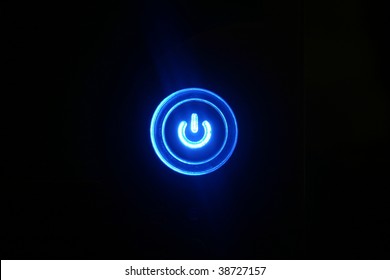 Power on - Blue glowing button on black background - Powered by Shutterstock