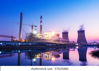 power plant near river at twilight - Powered by Shutterstock