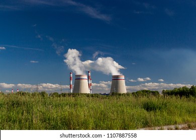 power plant pipes on the background of green grass, ecology