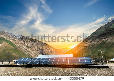 Power plant using renewable solar energy with sunset over the Gap in the Himalayan Mountain, Kashmir, India