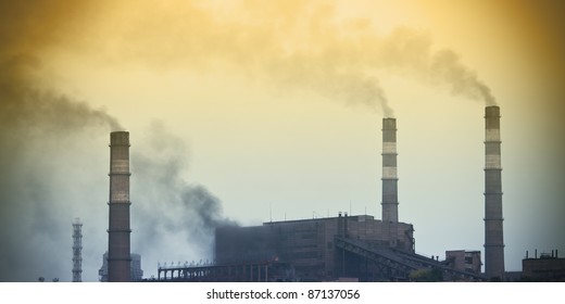 Power plant with yellow smoke - Shutterstock ID 87137056