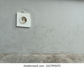 The Power Plug On The Left Side Of The Cement Wall With Copy Space. 