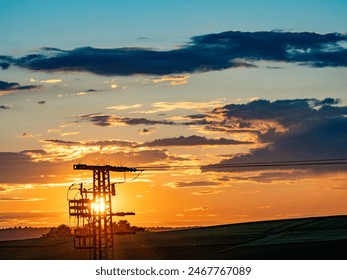 Power pole with transformer at sunset