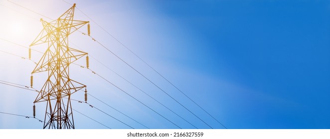 Power poles and power lines. Low Angle Shot Of Electric Poles on background blue sky. - Shutterstock ID 2166327559