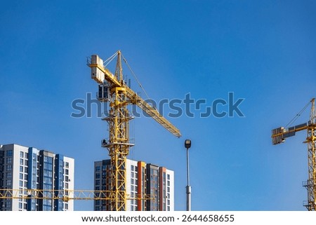 Power and precision of construction. Cranes in modern infrastructure. Building construction. Construction industry building. Construction industry site with cranes, fittings and concrete.