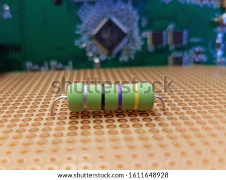 Power resistor on a prototype board with electronic circuit in background