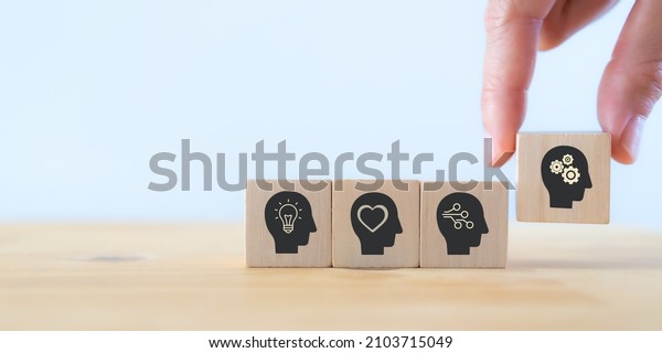 Power skills concept. Need of skills for digital\
and technology evolution. Soft skill,thinking skill, digital skill.\
Hand holds wooden cubes with \