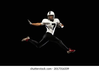 Power, Speed. Portrait Young American Football Player, Athlete In Black White Sports Uniform Training Isolated On Dark Studio Background. Concept Of Professional Sport, Championship, Competition. Back