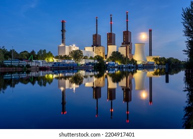 A power staion in Berlin at night with a perfect reflection in the water