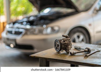 Power Steering Gear Pump Of The Car With Wrench Tools On Working Table In Repair And Maintenacne Garage 