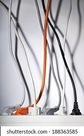 Power Strip And Power Cables Leading Vertically Upwards.