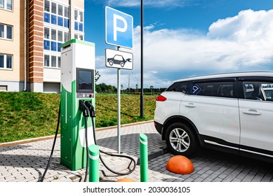 Power Supply For Charging Of Electric Car On Parking Lot. Electric Car Charching Station.