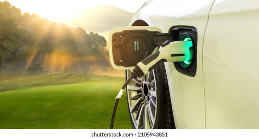 Power supply connect to electric car with nature background. Technology transport which are the future of the Automobile. Concept of reduce pollution, environment , Save the earth	 - Shutterstock ID 2105943851