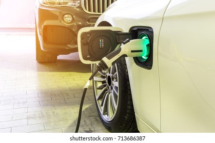 Power supply connect to electric car for add charge to the battery.  Charging re technology industry transport  which are the future of the Automobile.
 - Shutterstock ID 713686387