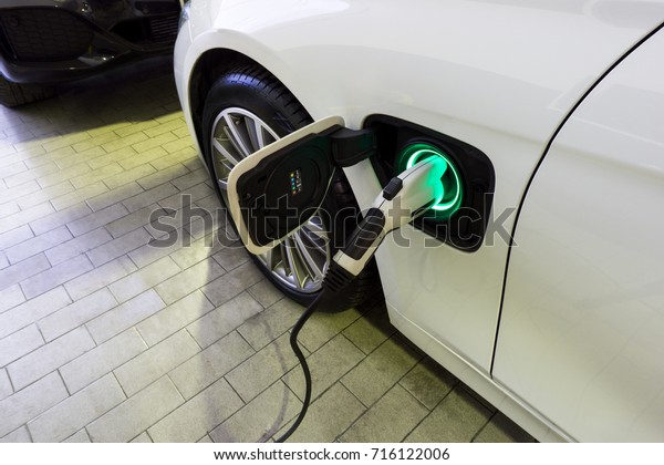 Power supply connect to electric car for\
add charge to the battery. Charging re technology industry\
transport which are the future of the\
Automobile.