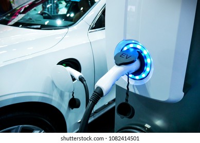 Power supply connect to electric vehicle for charge to the battery. Charging technology industry transport which are the futuristic of the Automobile. EV fuel Plug in hybrid car. - Shutterstock ID 1082414501