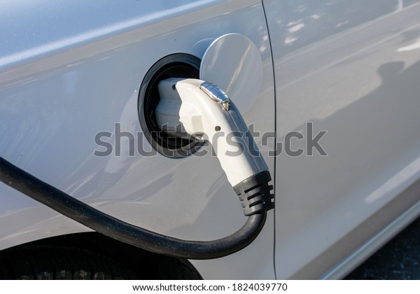 Power supply connects to an electric vehicle to\
charge the car battery.