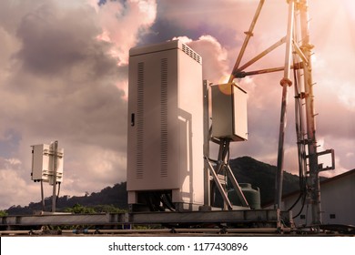 Power Supply And Electronics Switching Module For Smartphone Small Cell Site On Rooftop Of Commercial Building With Cloud Mountain And Sunray In Background.
4G Antenna System With Lens Flare Efect.