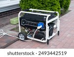 Power supply generator placed on street sidewalk. outdoor diesel power generator in Ukraine.