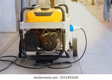 Power supply generator placed on street sidewalk. Outdoor diesel power generator. Small business use gasoline generators.