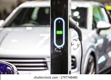 The power supply plugged into an electric car to charging a battery at the charging station - Shutterstock ID 1797748480