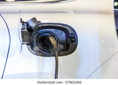  power supply plugged into an electric car - Shutterstock ID 273652343