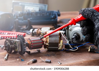 Power Tool Repair. Details Of Electrical Appliance And Repair Tools On A Wooden Table In A Repair Shop.