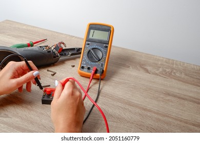 Power Tool Repair. Woman Repairing An Angle Grinder. Multimeter.