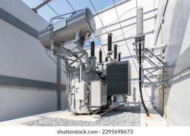 Power Transformer in High Voltage Electrical power electricity substation background.