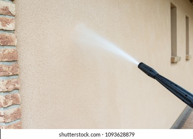 Power Washing The Wall - Cleaning The Facade Of The House