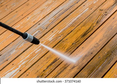 Power Washing. Wooden Deck Floor Cleaning With High Pressure Water Jet.